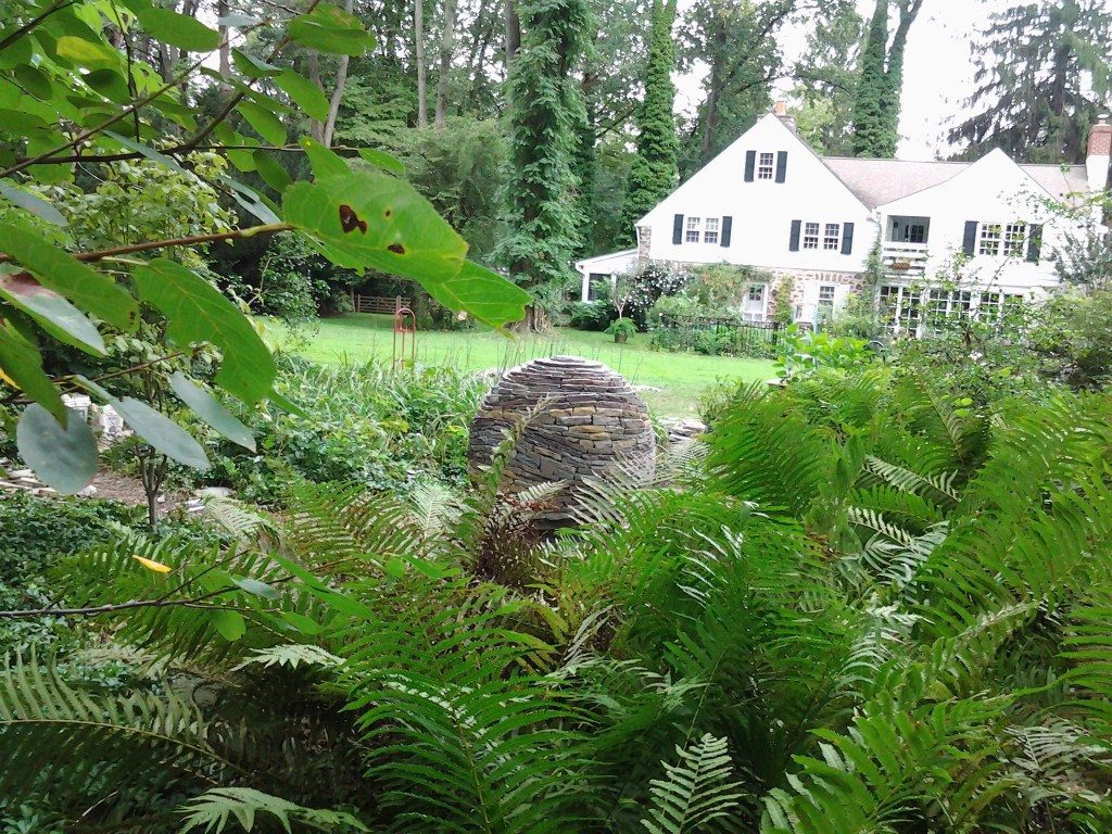 dry stone sphere and ferns