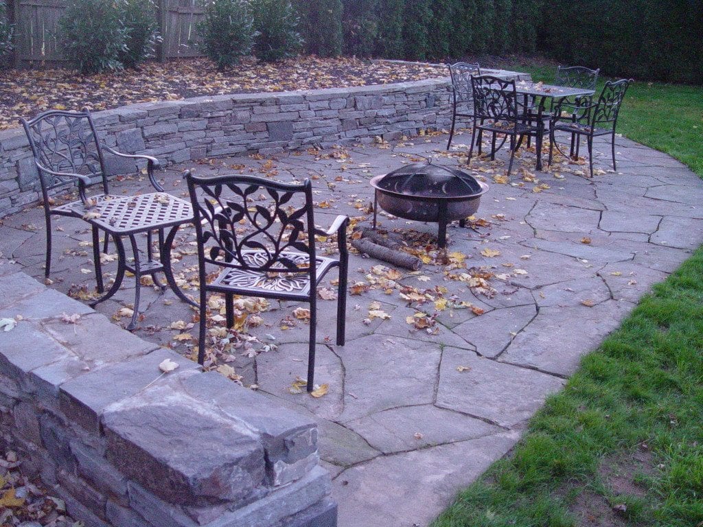 Flagstone patio and sitting wall, Abington PA by the mason at Devine Escapes