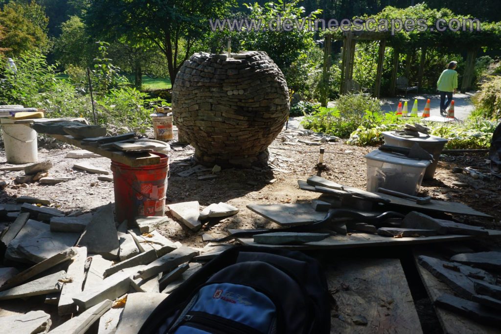 A big, beautiful serpent came and visited the jobsite, just as I was nearing completion of the sphere sculpture at Brookside Gardens. About 6 feet long, beautiful, beautiful, she moved by real slowly, giving me plenty of time to appreciate the black scales of her back, her mottled underbelly, her black forked tongue and her sinuous serpentine movement.