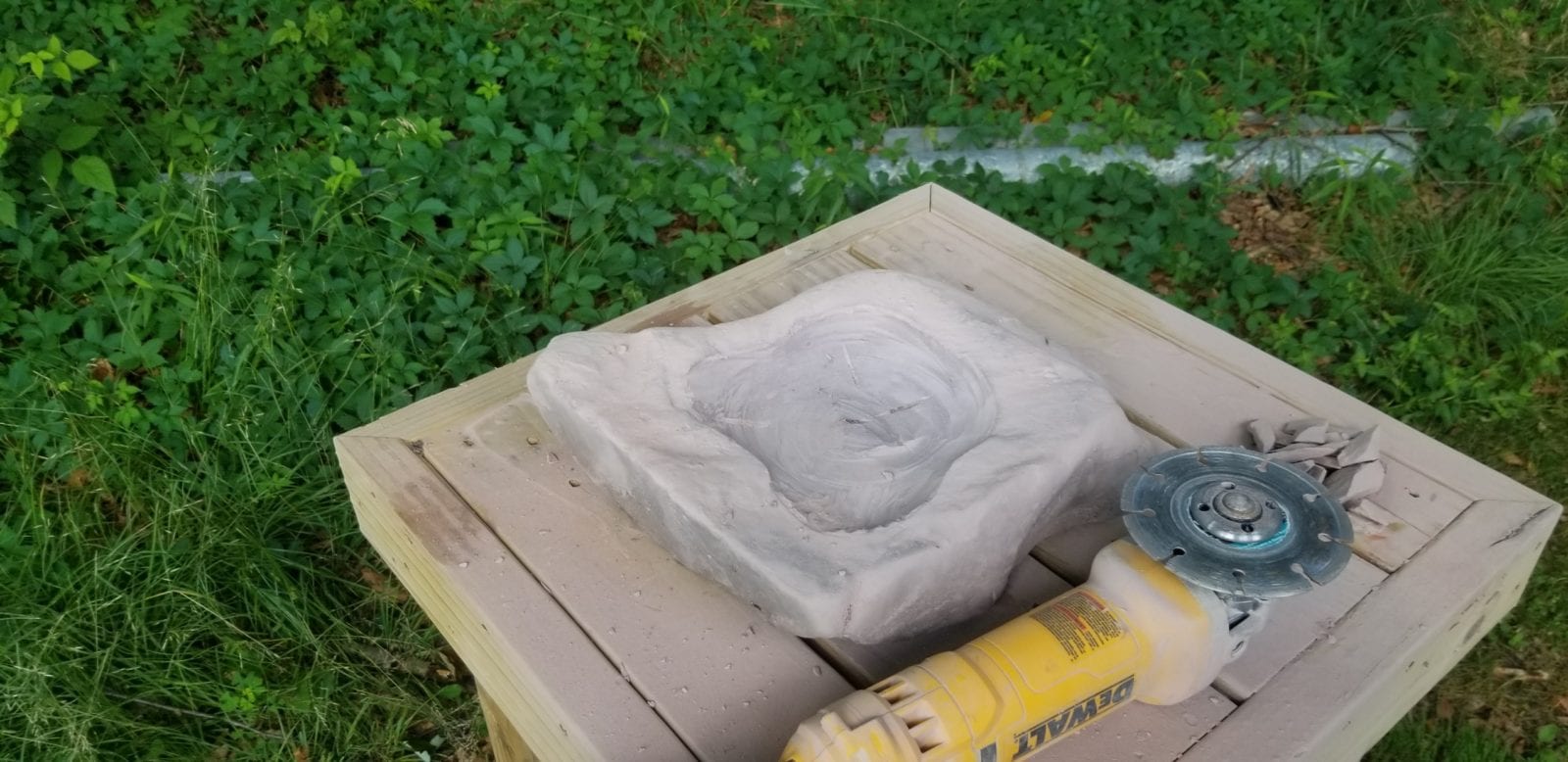 carving stone birdbath with angle grinder