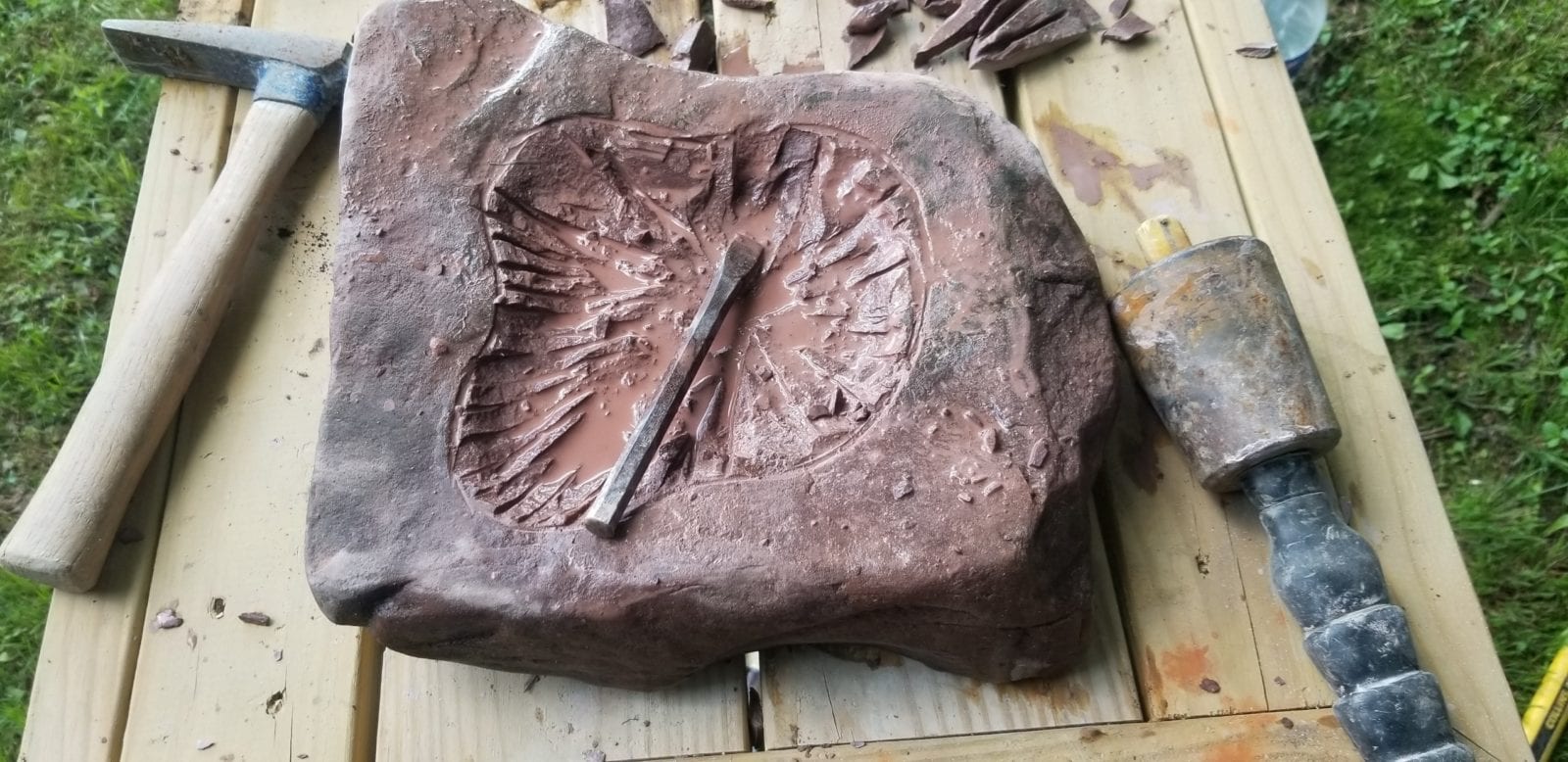 carving a stone birdbath