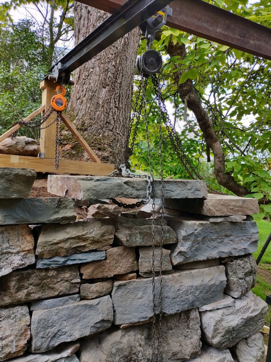 large dry stone wall being built with a gantry crane