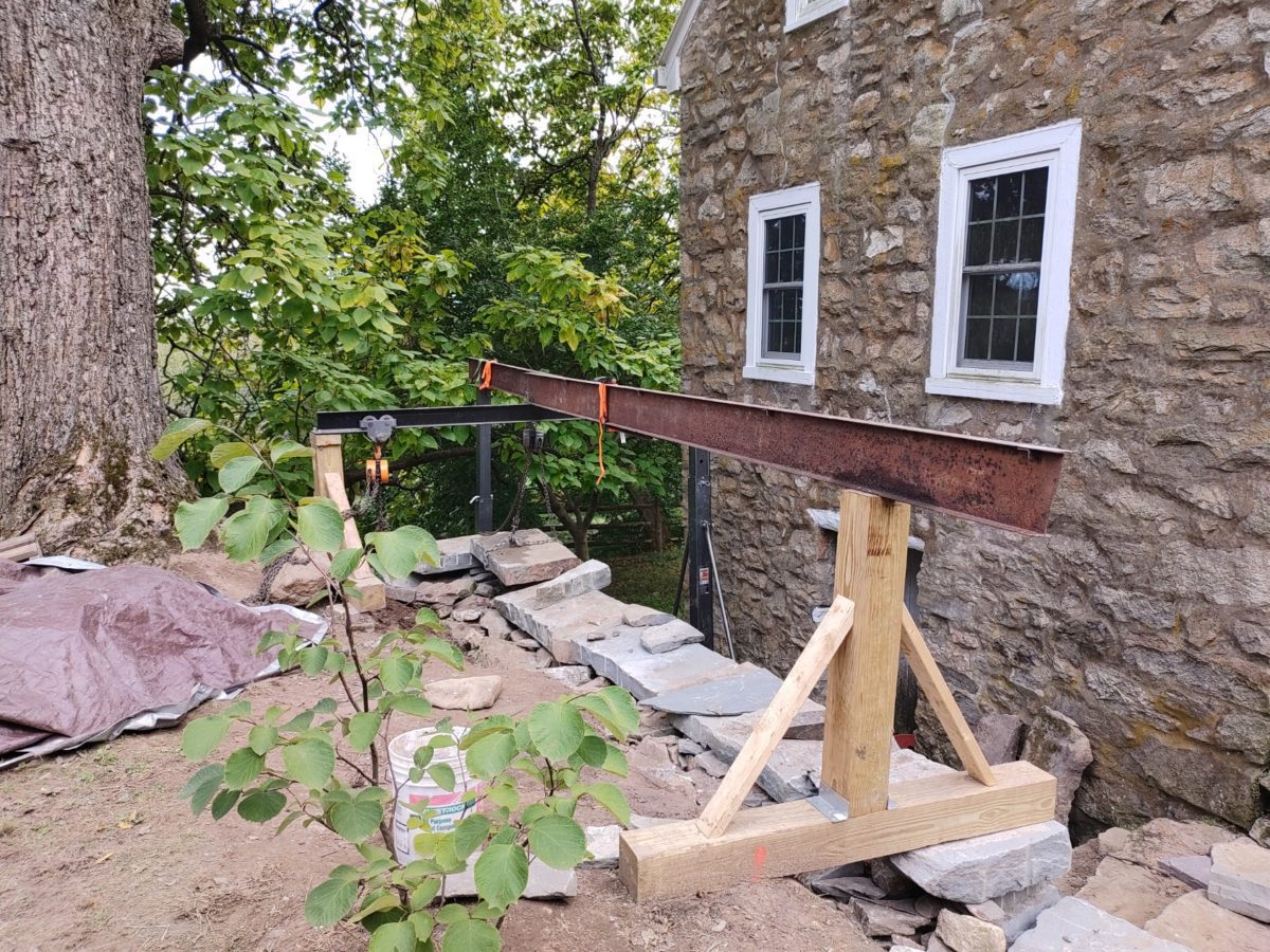 large stone wall built with crane