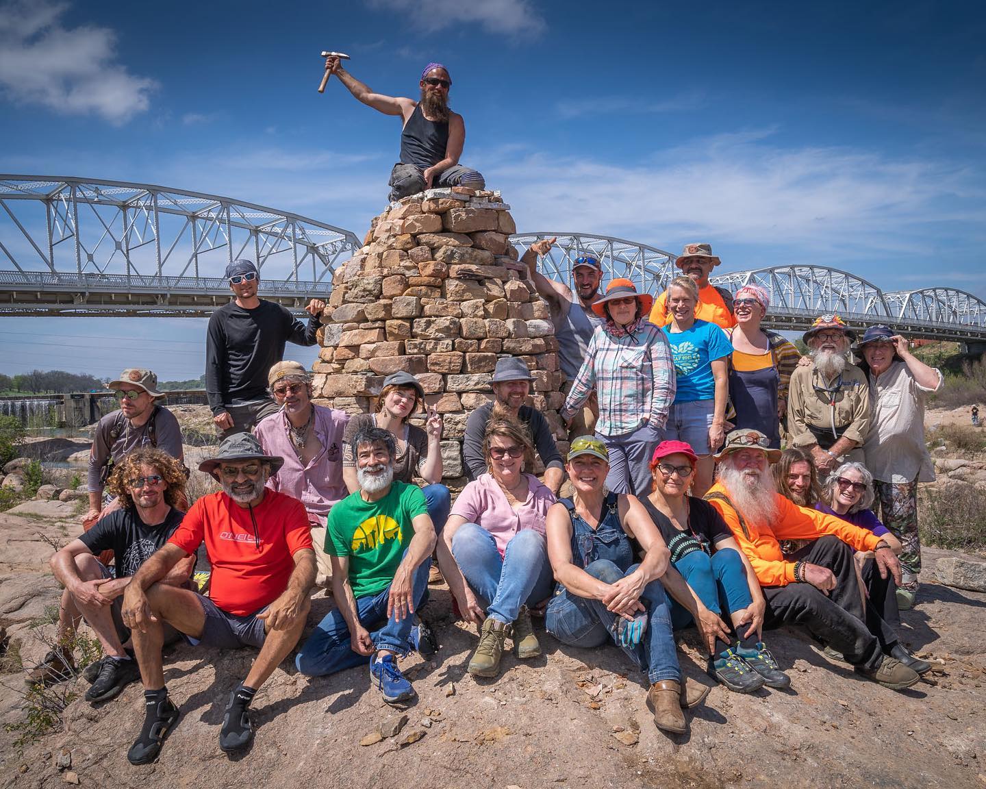 group of land artists in front of devin devine's piece