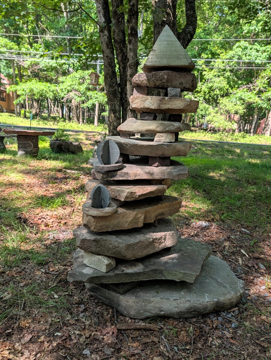 land art sculpture cairn with carved pyramid top